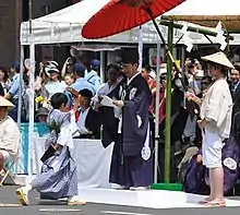 1500年（明応9年）侍所開闔 松田豊前守頼亮により始められた「くじ取り式」、「くじ改め」で奉行役を務める京都市長（2019年、後の祭り）