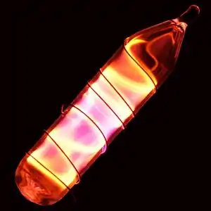 Glass tube shining orange light with a wire wound over it